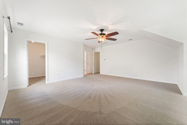 empty room featuring ceiling fan, light colored carpet, and baseboards