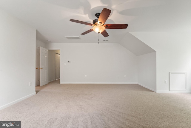 bonus room featuring light colored carpet, ceiling fan, and baseboards