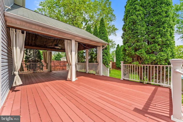 wooden deck with a ceiling fan
