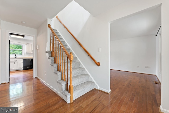 stairs with wood-type flooring and baseboards