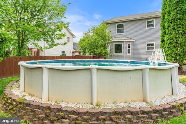 view of pool featuring fence
