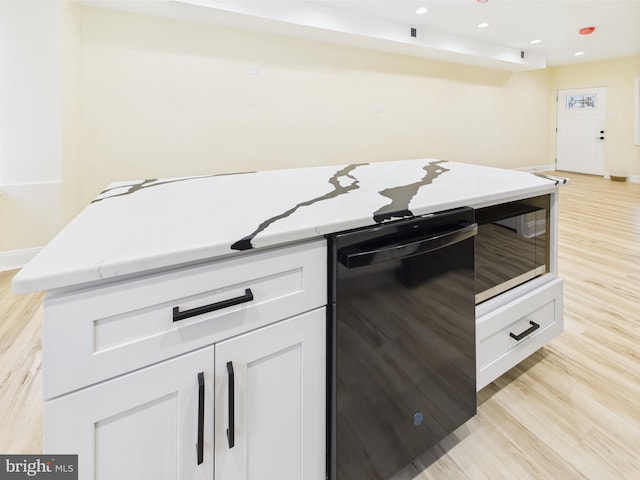5135 N Fairhill St, Philadelphia, PA 19120 - kitchen with black dishwasher, light stone countertops, light wood finished floors, baseboards, and recessed lighting