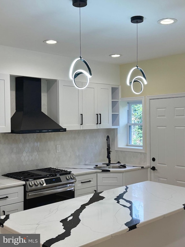 5135 N Fairhill St, Philadelphia, PA 19120 - kitchen featuring exhaust hood, gas stove, white cabinetry, a sink, and light stone countertops