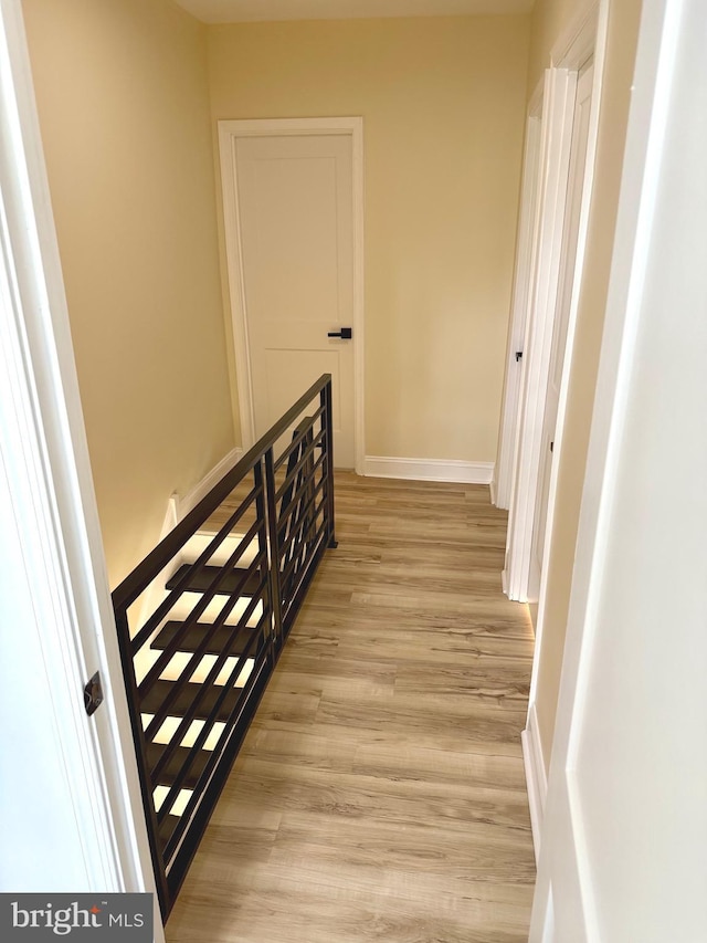 5135 N Fairhill St, Philadelphia, PA 19120 - corridor with light wood finished floors, baseboards, and an upstairs landing
