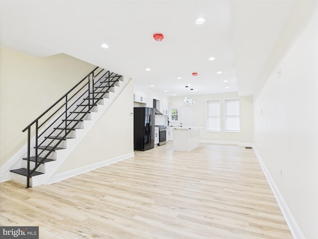 5135 N Fairhill St, Philadelphia, PA 19120 - unfurnished living room with light wood-style flooring, stairway, baseboards, and recessed lighting