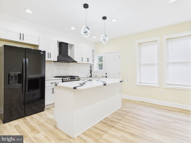 5135 N Fairhill St, Philadelphia, PA 19120 - kitchen featuring black fridge, wall chimney exhaust hood, light wood finished floors, decorative backsplash, and recessed lighting