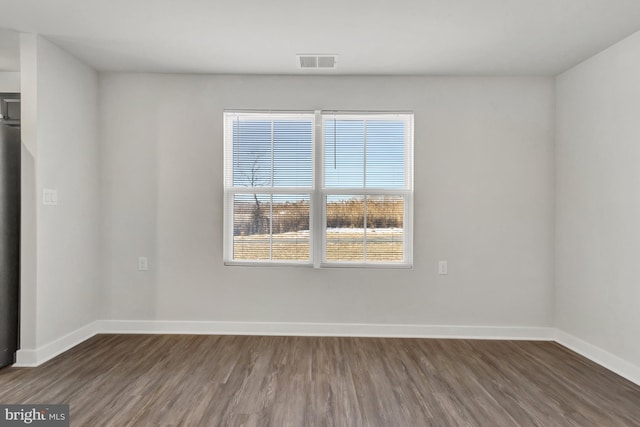 28010 Dew Drop Ln, Millville, DE 19967 - empty room featuring baseboards, wood finished floors, and visible vents