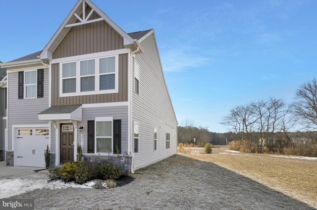 28010 Dew Drop Ln, Millville, DE 19967 - view of front facade featuring a garage, board and batten siding, driveway, and stone siding