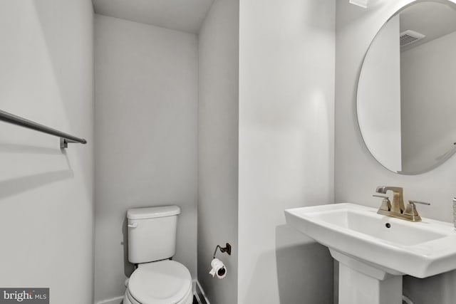 28010 Dew Drop Ln, Millville, DE 19967 - half bath featuring a sink, toilet, and visible vents