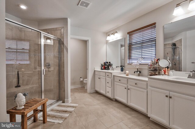 3911 Dewalt St, Bethlehem, PA 18020 - full bath with visible vents, tile patterned flooring, double vanity, a sink, and a stall shower