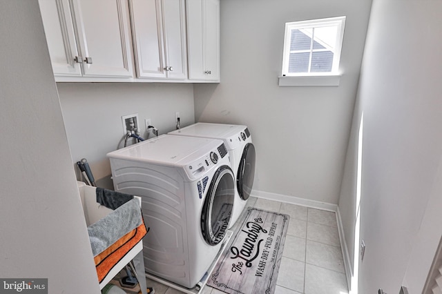 3911 Dewalt St, Bethlehem, PA 18020 - laundry area featuring light tile patterned floors, baseboards, washing machine and dryer, and cabinet space
