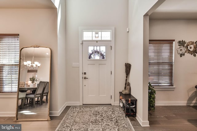 3911 Dewalt St, Bethlehem, PA 18020 - foyer entrance with baseboards, a notable chandelier, dark wood-style floors, and a high ceiling