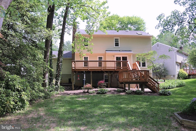 back of property with a wooden deck, stairs, and a yard