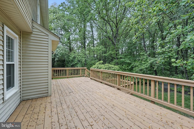 deck featuring view of scattered trees