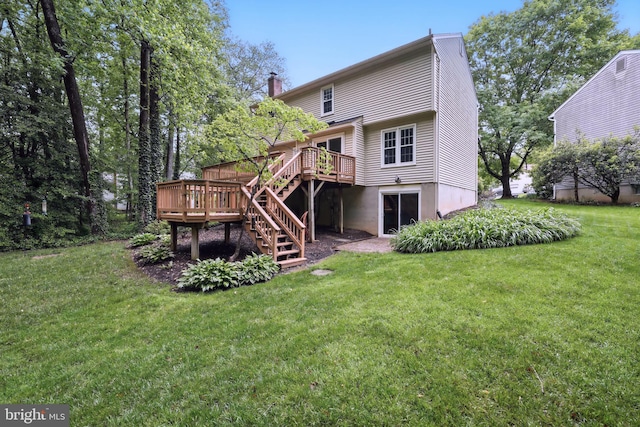 rear view of house with a deck, stairway, a yard, and a chimney