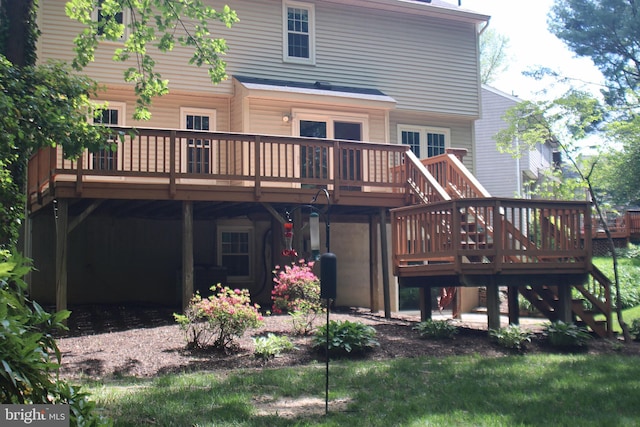 rear view of house with a deck and stairway