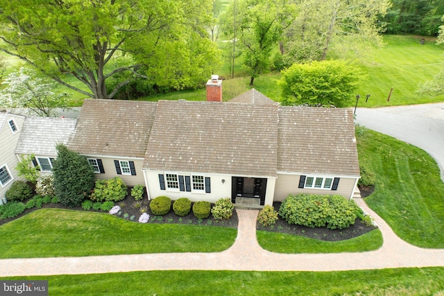 exterior space with a front lawn and a chimney