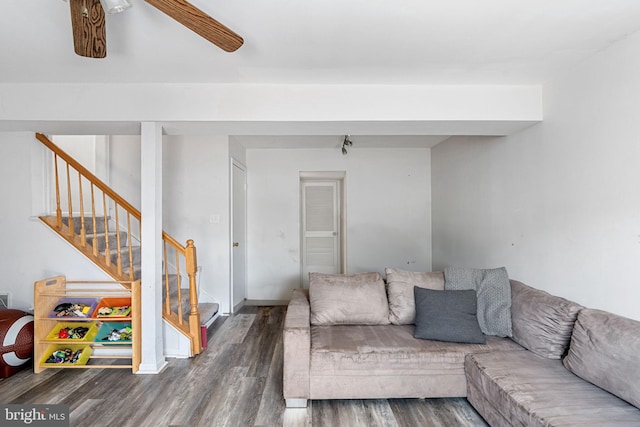 living area with wood finished floors, stairs, and ceiling fan
