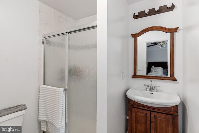 full bath with a stall shower, toilet, vanity, ceiling fan, and connected bathroom
