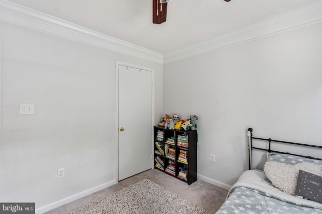 bedroom with carpet floors, ornamental molding, baseboards, and a ceiling fan