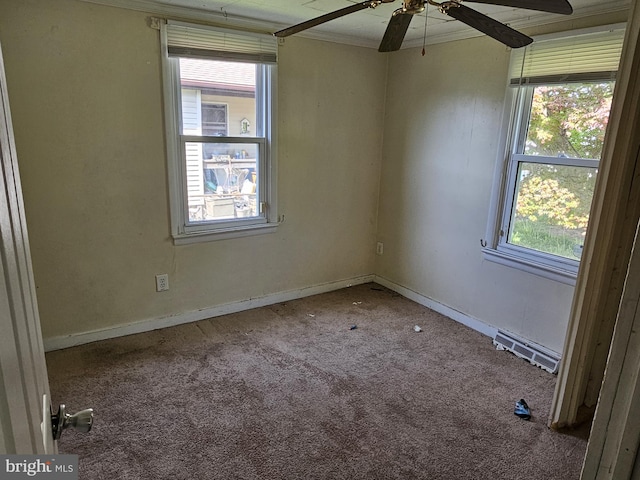 carpeted empty room with visible vents, ornamental molding, plenty of natural light, and ceiling fan