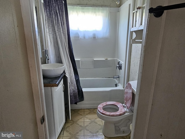 full bath featuring vanity, shower / bath combo with shower curtain, and toilet