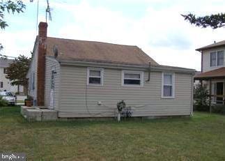 rear view of house with a lawn and a chimney