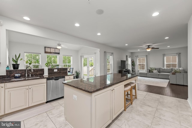 8365 Eagle St, Glen Burnie, MD 21060 - kitchen featuring stainless steel dishwasher, ceiling fan, a sink, open floor plan, and healthy amount of natural light