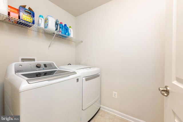 8365 Eagle St, Glen Burnie, MD 21060 - washroom with washer and clothes dryer, light tile patterned floors, and baseboards