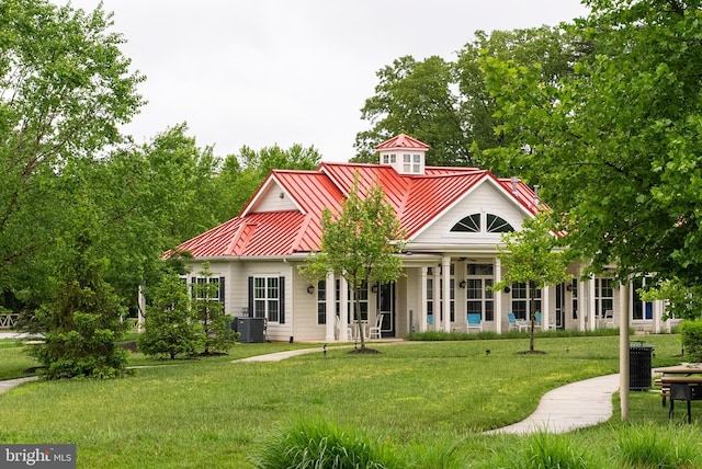 8365 Eagle St, Glen Burnie, MD 21060 - view of front of home with a standing seam roof, central AC, a front yard, and metal roof