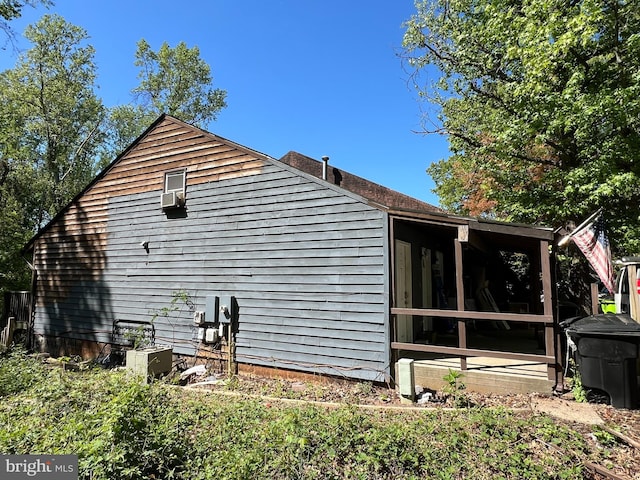 view of home's exterior with a sunroom