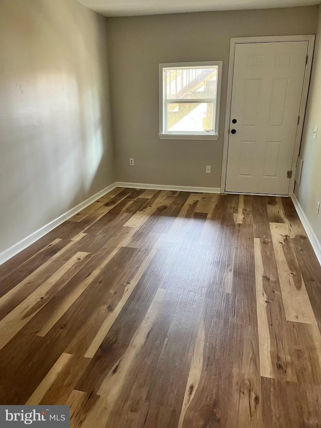entrance foyer with baseboards and wood finished floors