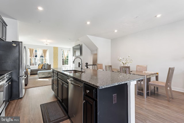9912 Vista Pointe Dr, Upper Marlboro, MD 20774 - kitchen with appliances with stainless steel finishes, a sink, light wood-style floors, a kitchen island with sink, and open floor plan