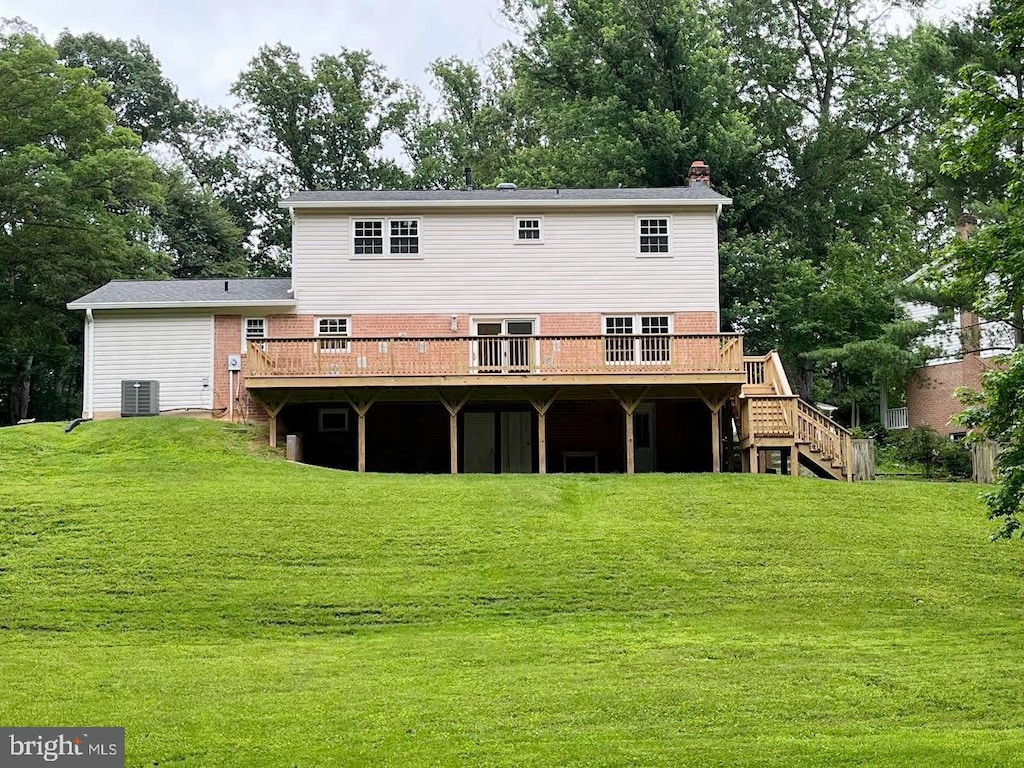 8817 Bridle Wood Dr, Springfield, VA 22152 - back of property with a wooden deck, stairs, a chimney, and a yard