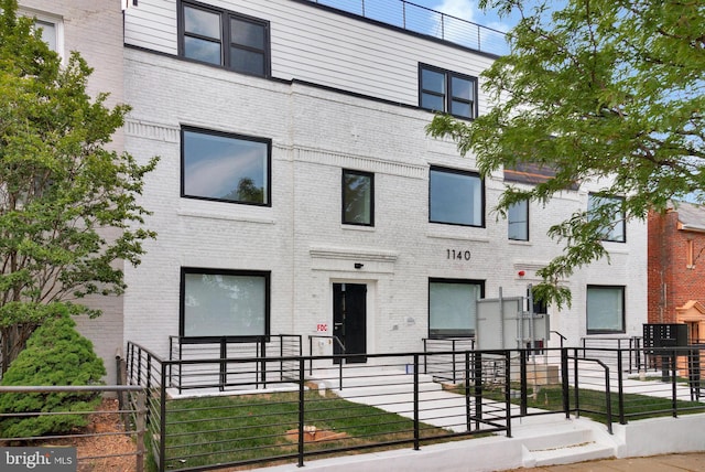 view of building exterior with fence private yard
