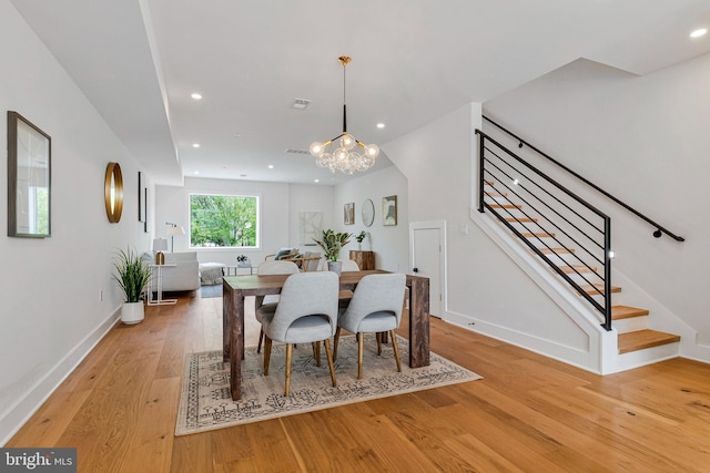 dining space featuring stairway, baseboards, a chandelier, light wood-style floors, and recessed lighting