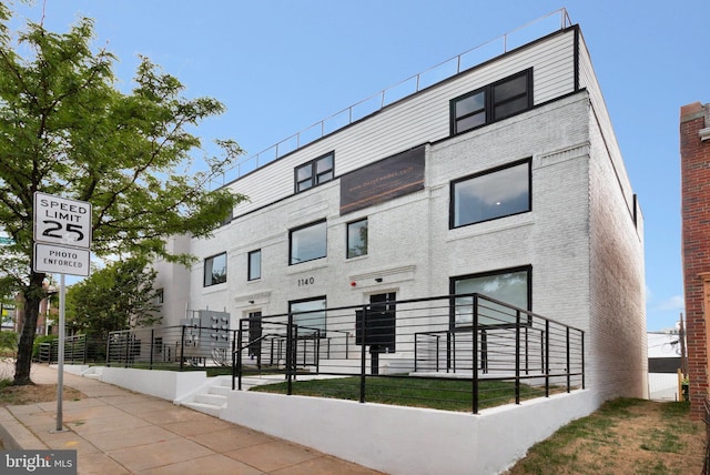 view of building exterior with fence