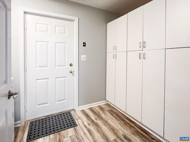interior space featuring baseboards and wood finished floors
