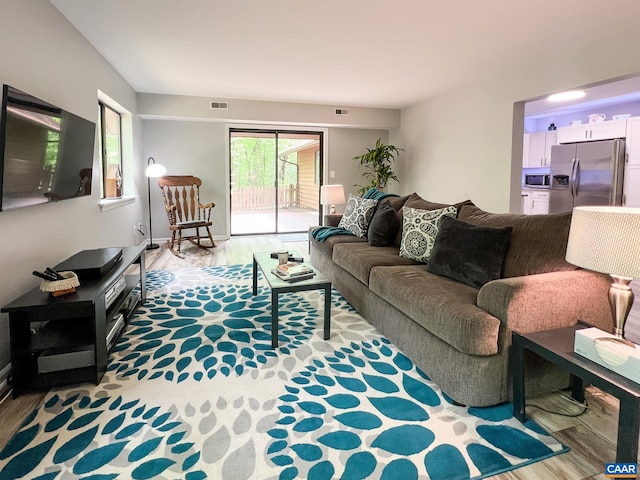 living room with visible vents and wood finished floors