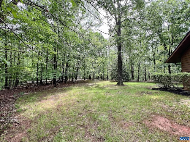 view of yard with a view of trees