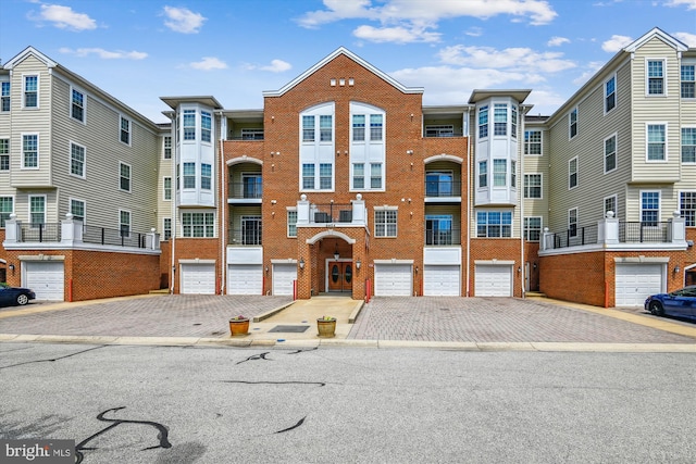 view of building exterior featuring driveway and a garage