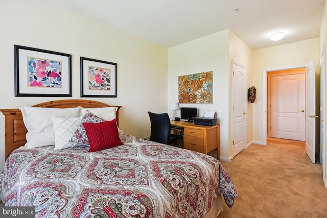bedroom featuring light carpet and baseboards