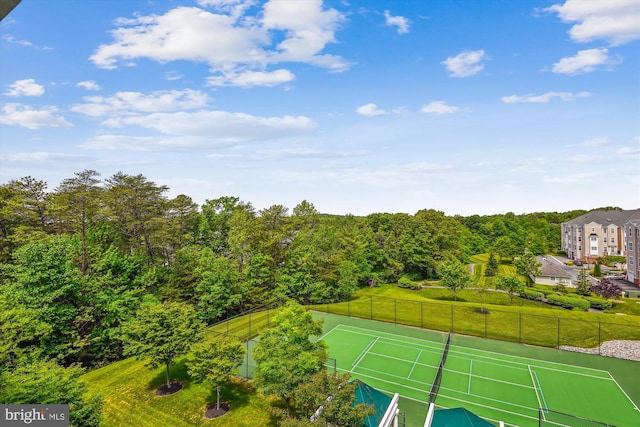 view of tennis court featuring fence