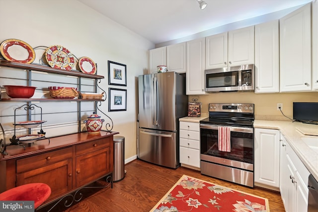 kitchen featuring stainless steel appliances, dark wood-style floors, light countertops, and white cabinetry