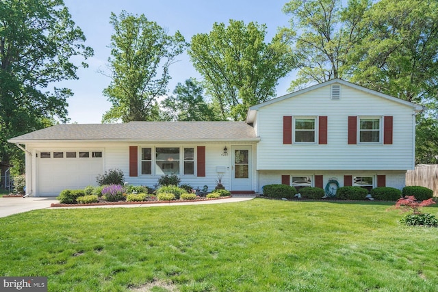 split level home featuring brick siding, a garage, a front lawn, and driveway