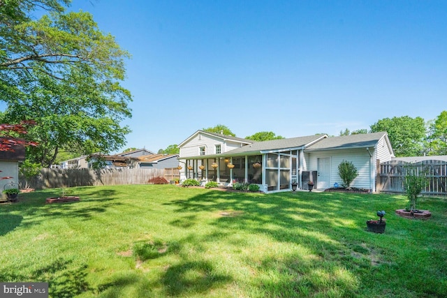 view of yard featuring a fenced backyard and a sunroom