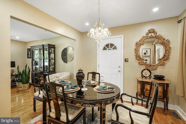 dining room featuring light wood-type flooring, recessed lighting, visible vents, and an inviting chandelier