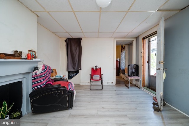 interior space with wood finished floors, baseboards, and a drop ceiling