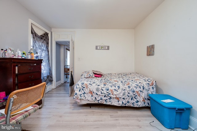 bedroom with wood finished floors and baseboards