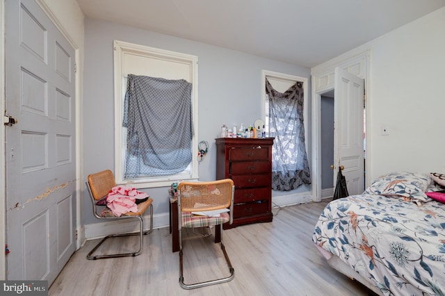 bedroom with baseboards and light wood-style floors